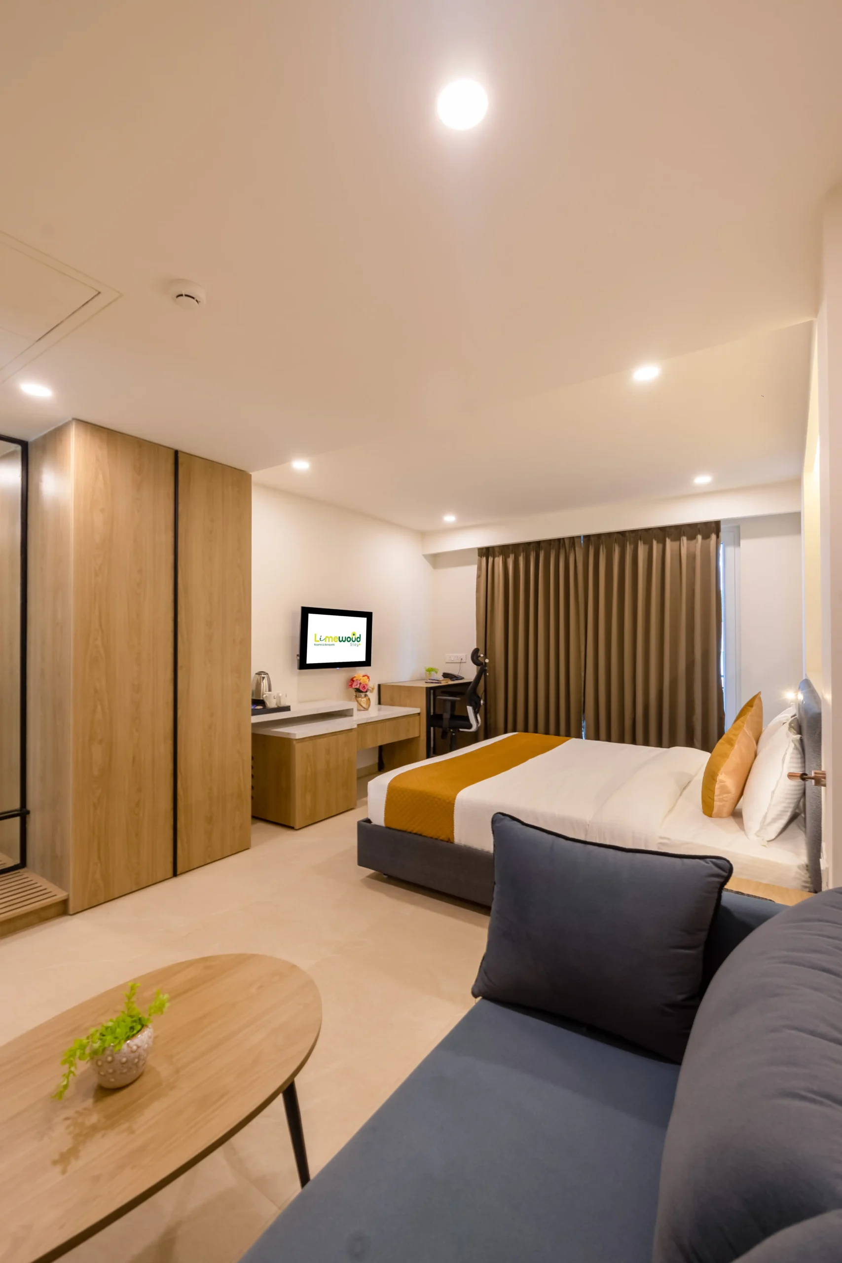 Limewood luxury suite interior with comfortable bed, warm lighting, wardrobe, and seating